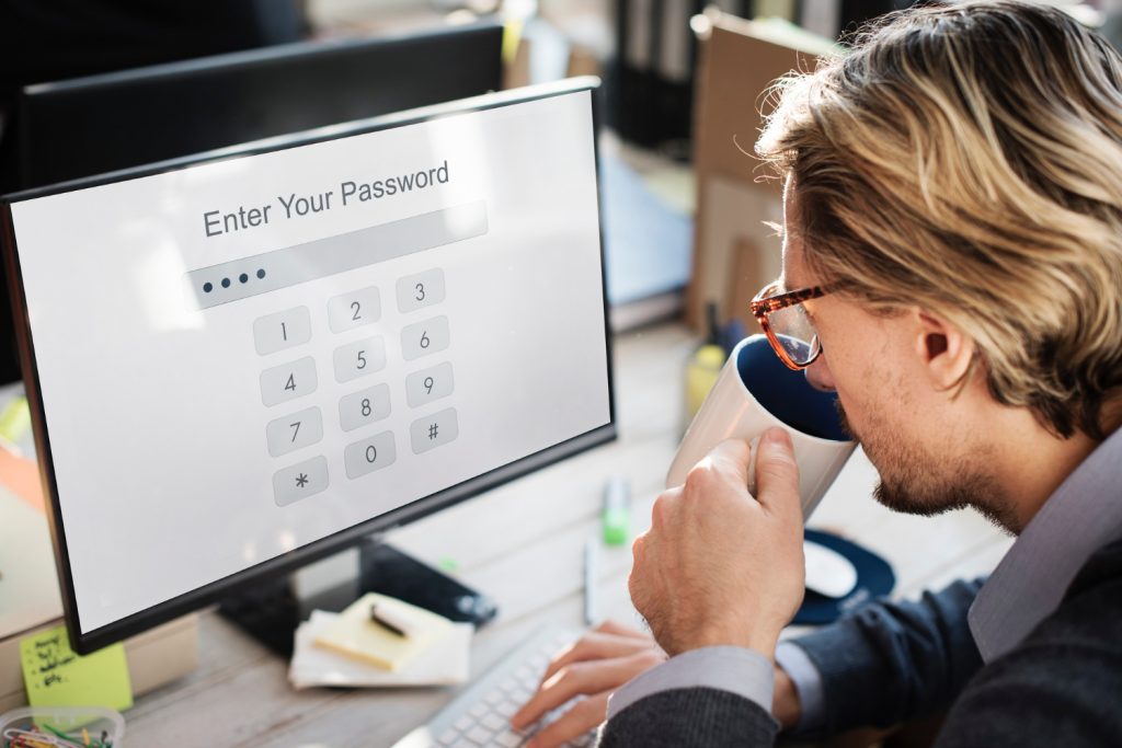 Photo of person at computer entering password