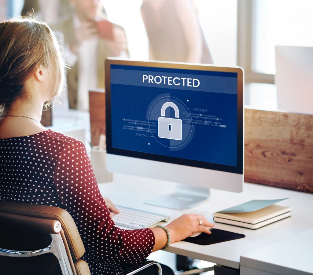Photo of woman at a computer with "Protected" on the screen